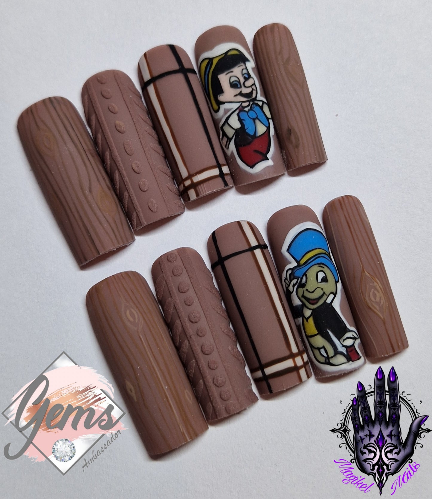 Autumn press on nails featuring wood grain effect,  sweater and tartan with wooden boy and friend